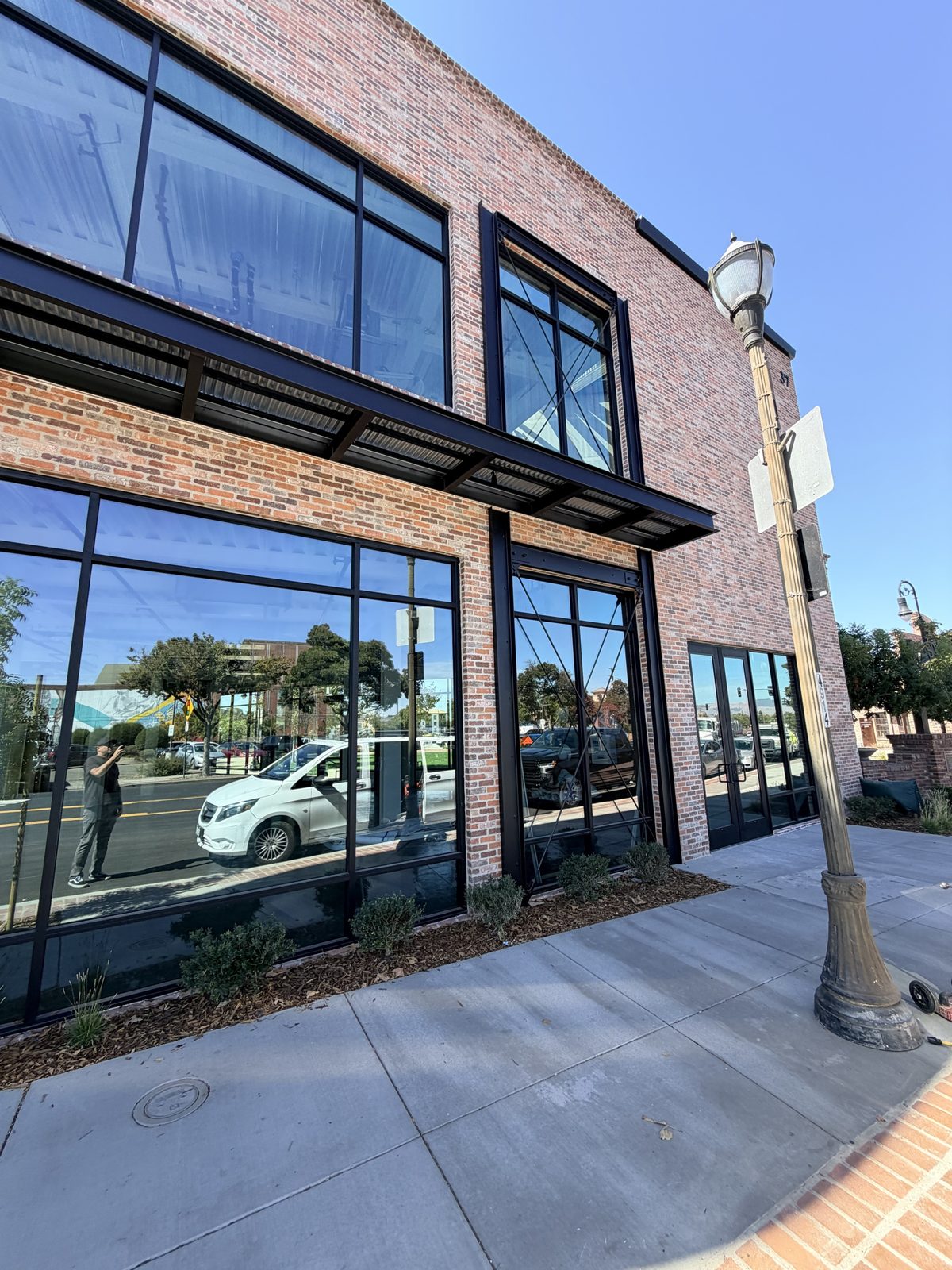 Black steel awning and storefront frames on a brick building in downtown Livermore