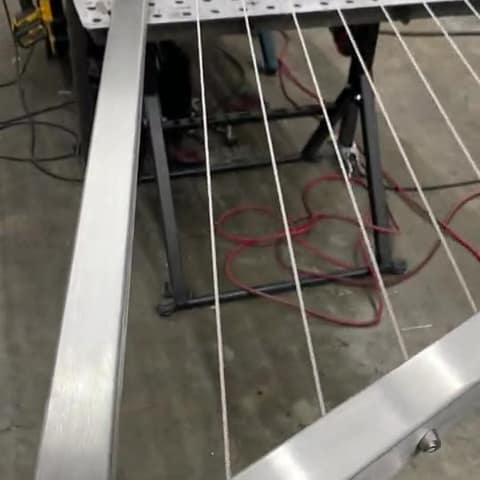 Short video: a brushed stainless steel cable railing panel on the fabrication table in the Duran shop.